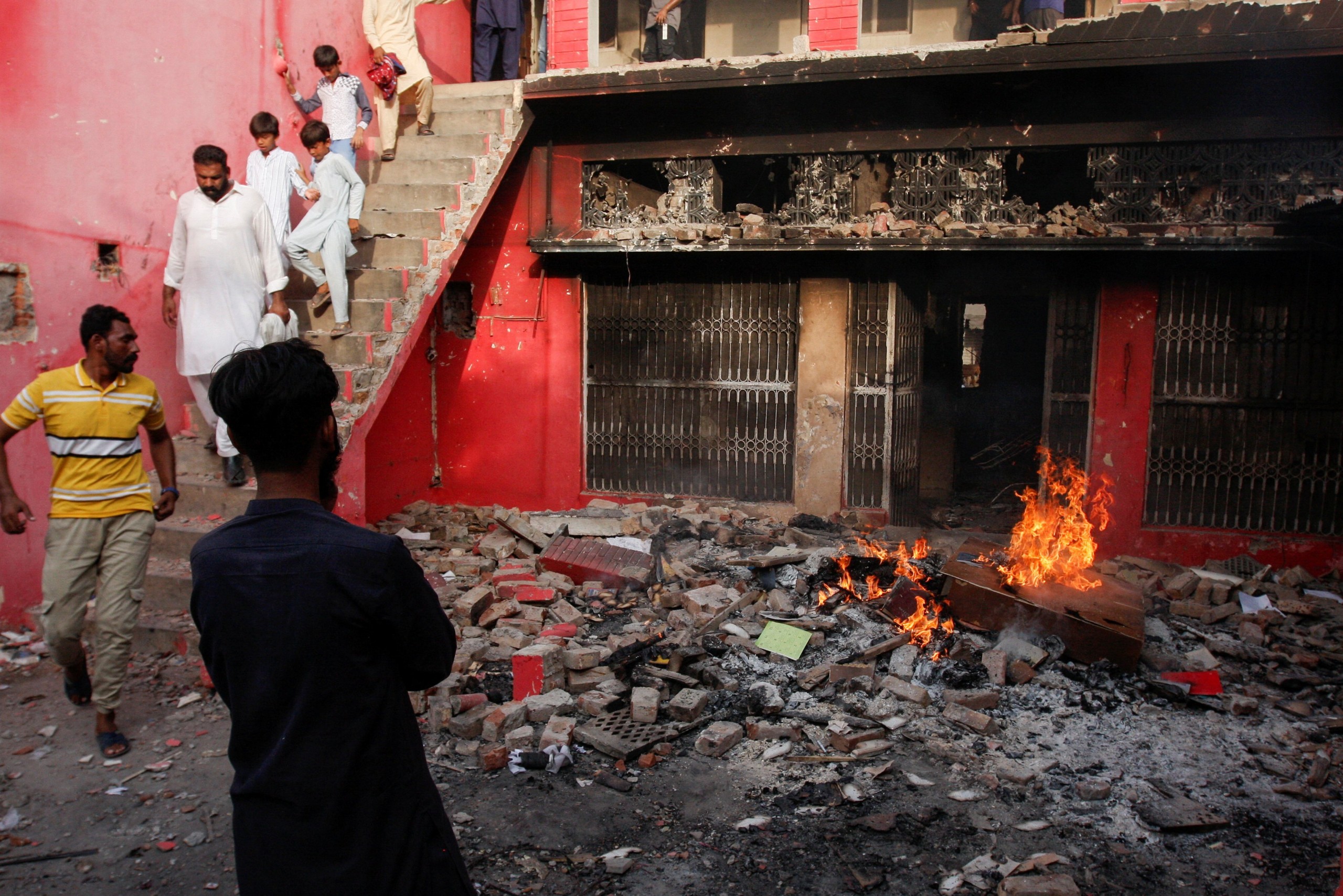 People gather at a church building vandalized by protesters in Jaranwala, Pakistan, Aug. 16, 2023. A Muslim crowd vandalized churches and torched homes after two Christians were accused of blasphemy. (OSV News photo/Fayyaz Hussain, Reuters)