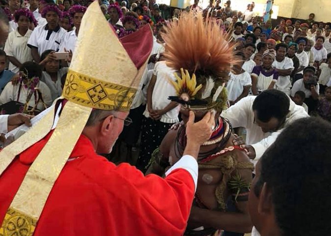 Bishop Donald F. Lippert anoints a parishioner during a January 2019 confirmation ceremony in Papua New Guinea.