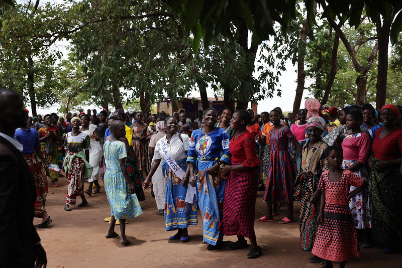 The Women of Chitula Parish gathering and singing in preparation for the outdoor mass after walking for miles in the hot African sun, anxiously awaiting the arrival of their visitors