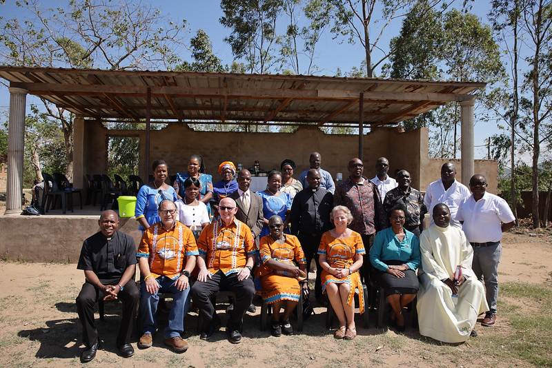 Members of the group from TPMS-USA pose for a photo with parishioners from the community after Mass