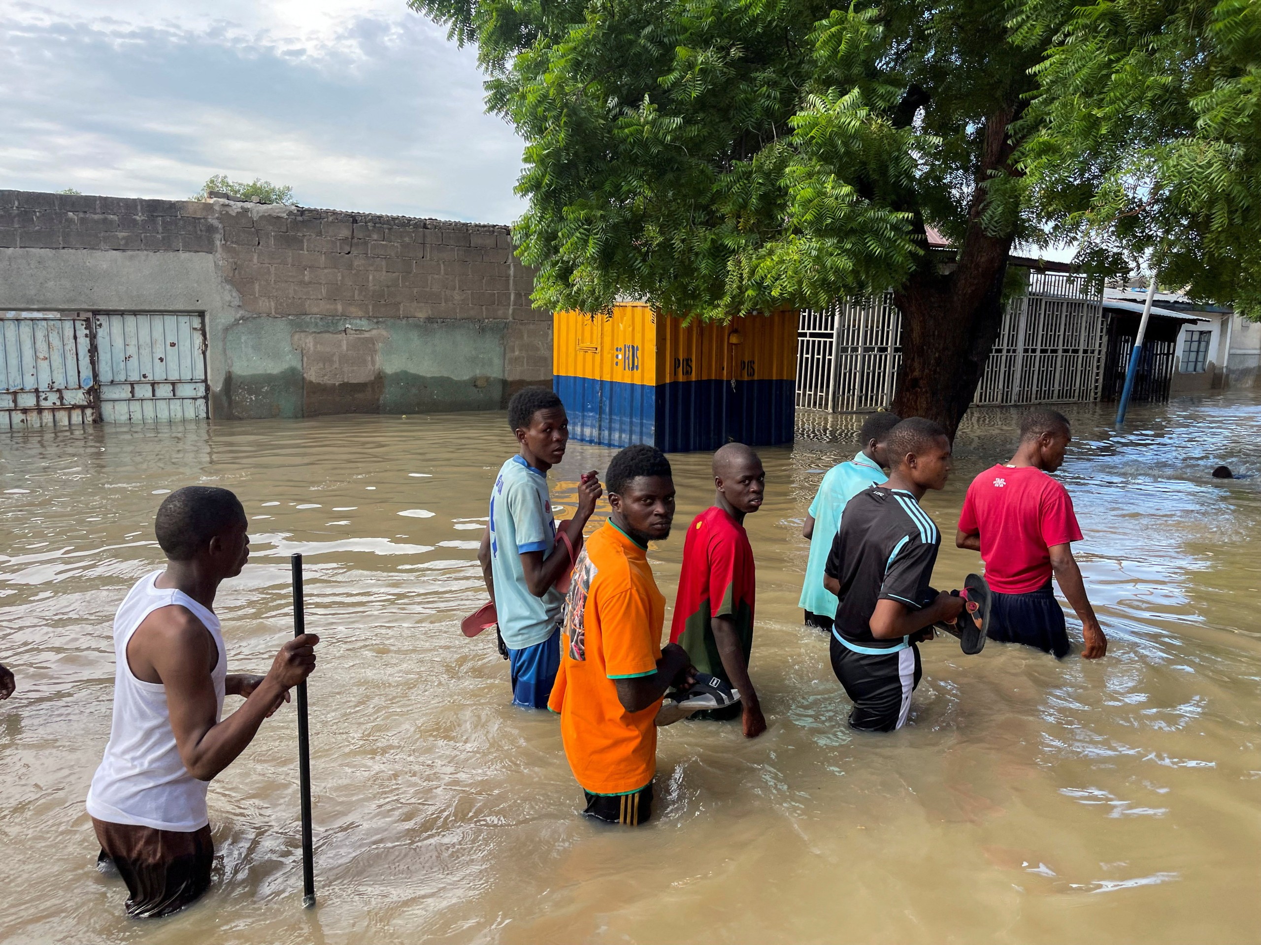 Flood victims walk along a flooded road as they move to safety, in Maiduguri, Nigeria, Sept. 12, 2024.