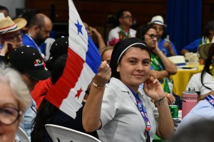 A missionary holds a flag of Panama during the speech by Archbishop Nieves on the opening day of CAM6.