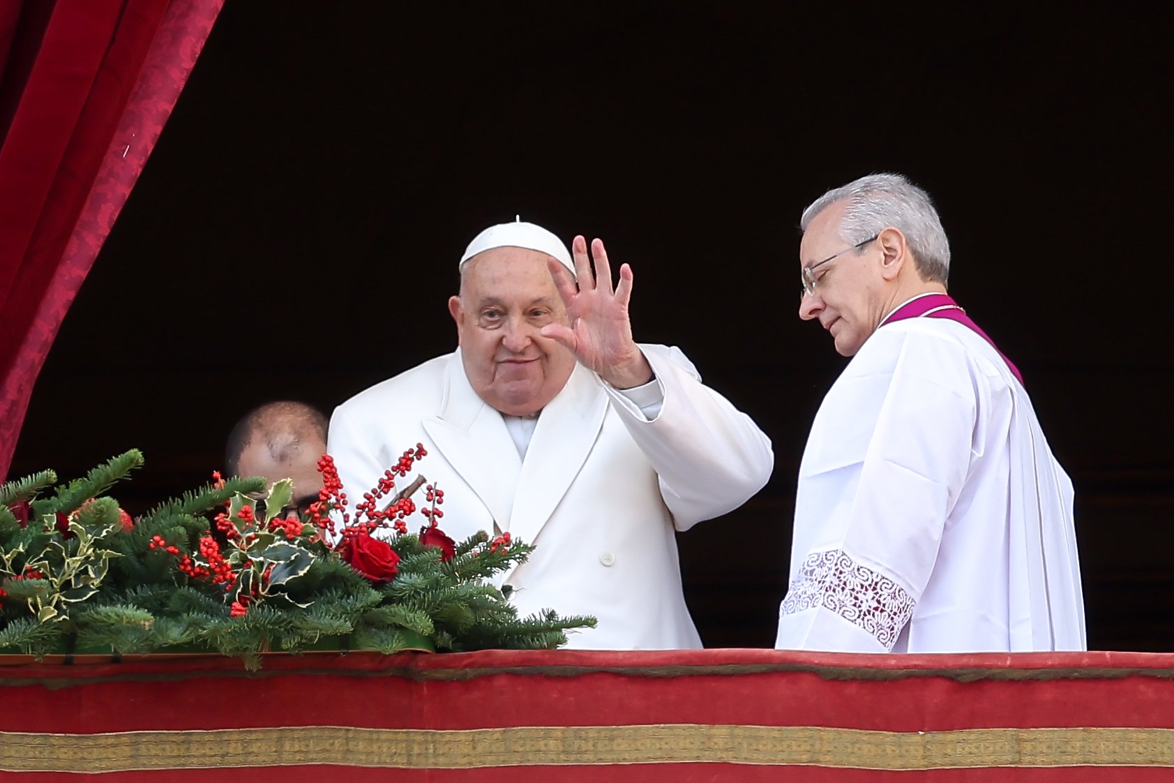 Pope Francis waves to visitors gathered in St. Peter's Square after delivering his Christmas message and blessing "urbi et orbi" (to the city and the world) from the central balcony of St. Peter's Basilica at the Vatican Dec. 25, 2024. (CNS photo/Lola Gomez)